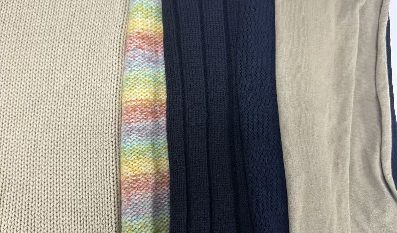Knitted fabric panels laid side by side to compare stitch density across our 3GG to 18GG gauge range