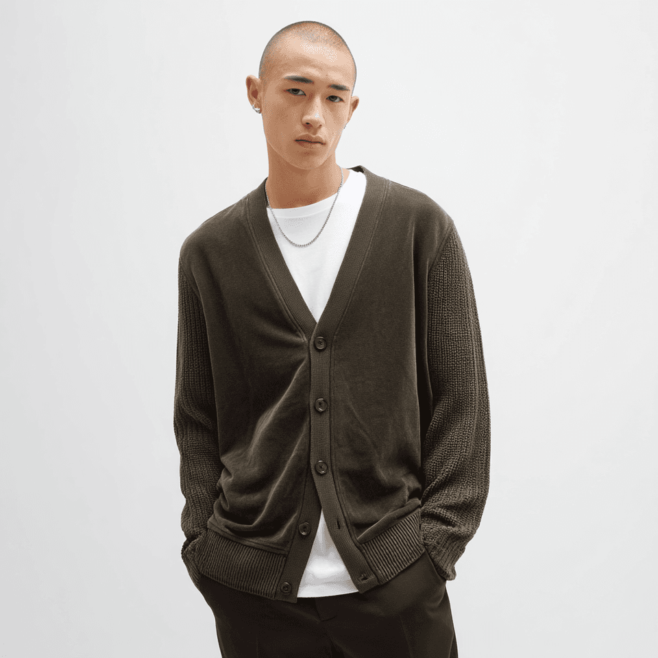 A dark brown suede-front cardigan jacket with ribbed knit sleeves and hem, worn - the suede-to-knit join this article is about