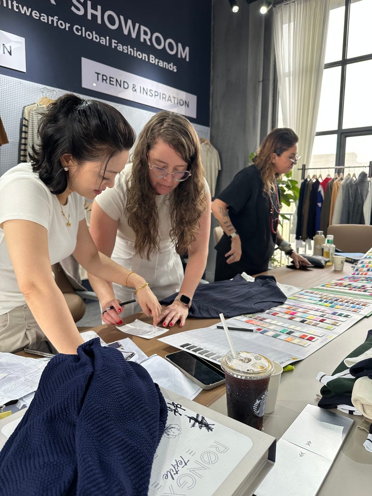 Discussing colors and samples with a buyer using Pantone swatch cards