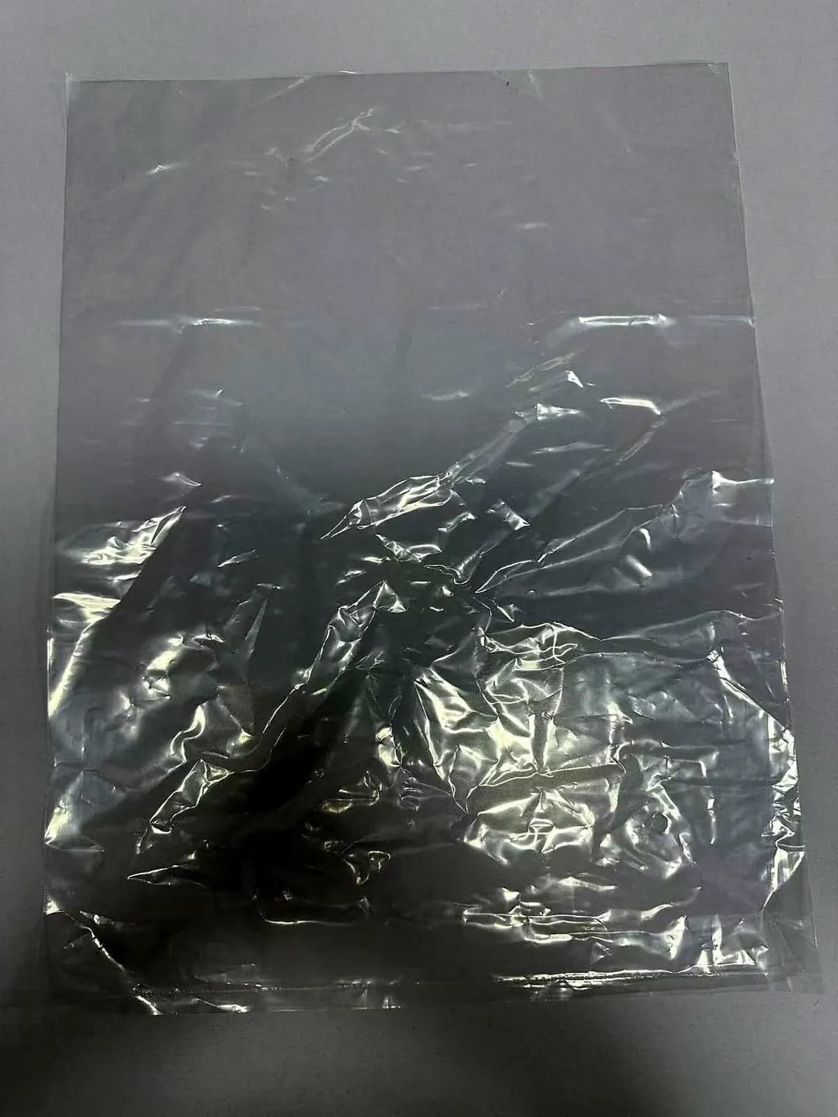 Single garment being polybagged at the packing bench