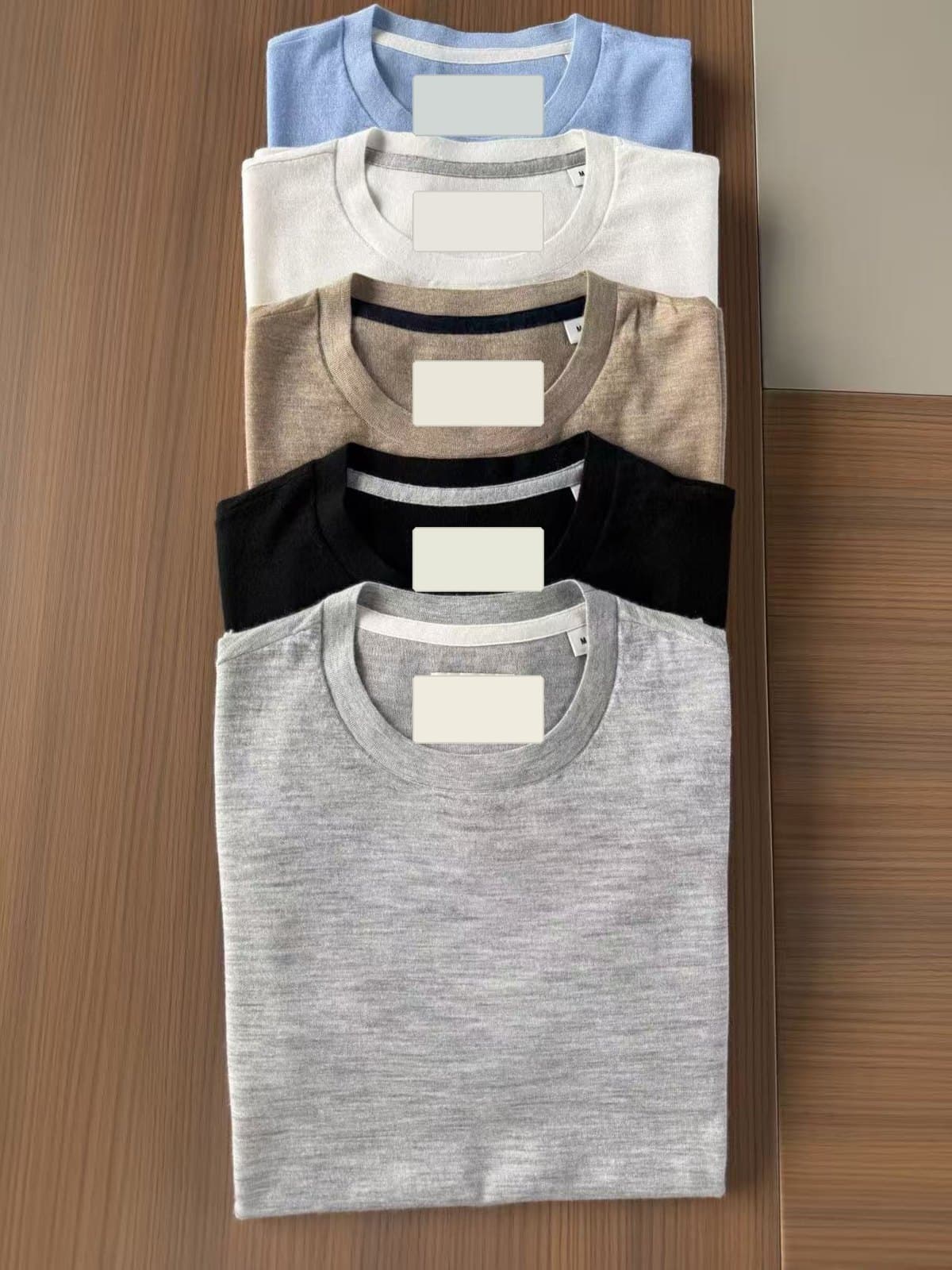 The same 18GG crew neck knitted in five colourways, folded and stacked