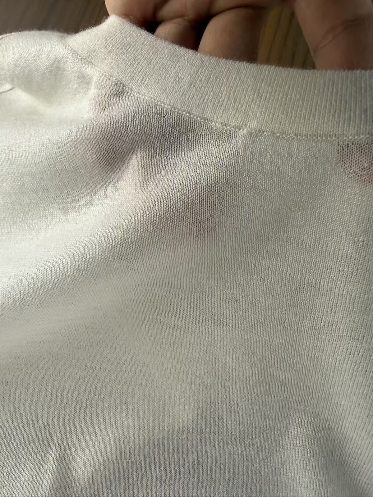 Neckline of a finished 18GG crew neck, stitch density visible along the rib