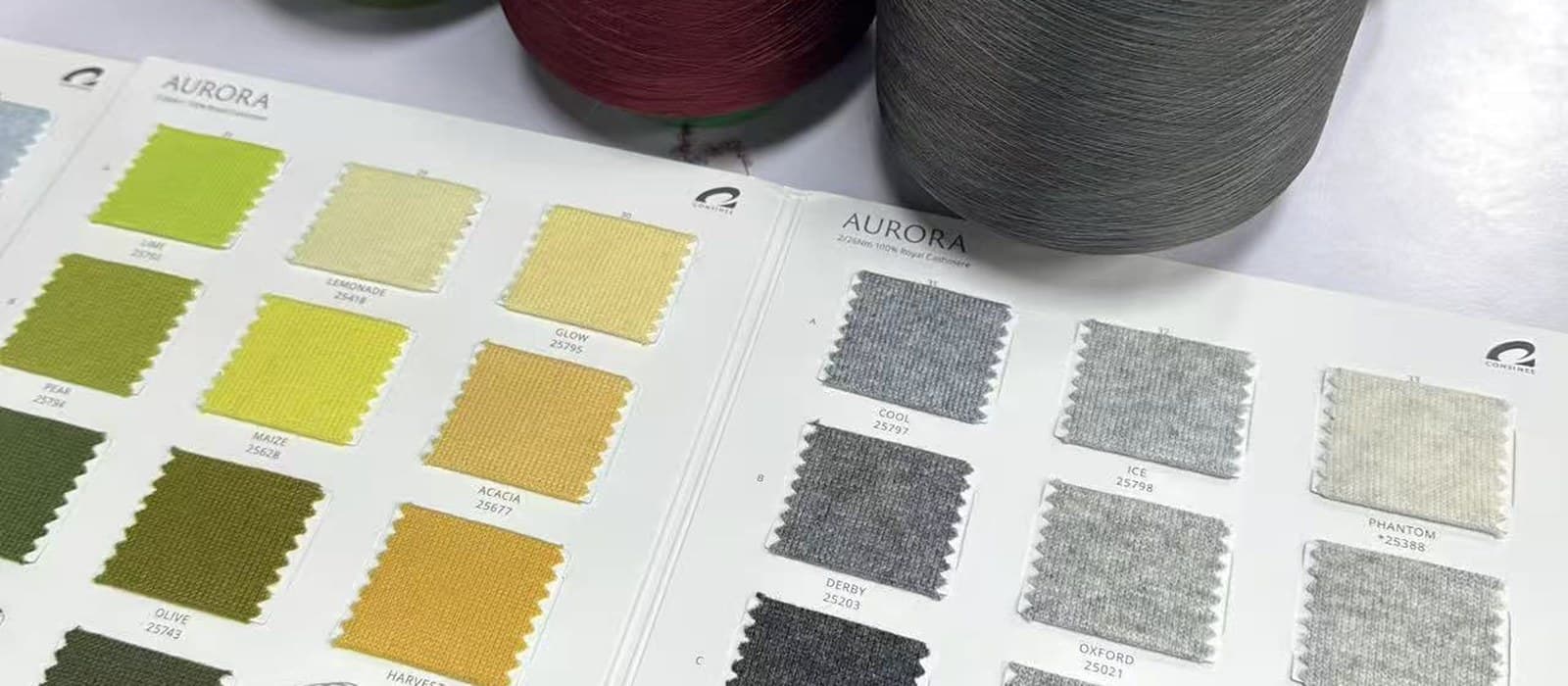 Physical yarn swatch cards laid out for colour and handfeel selection before sampling