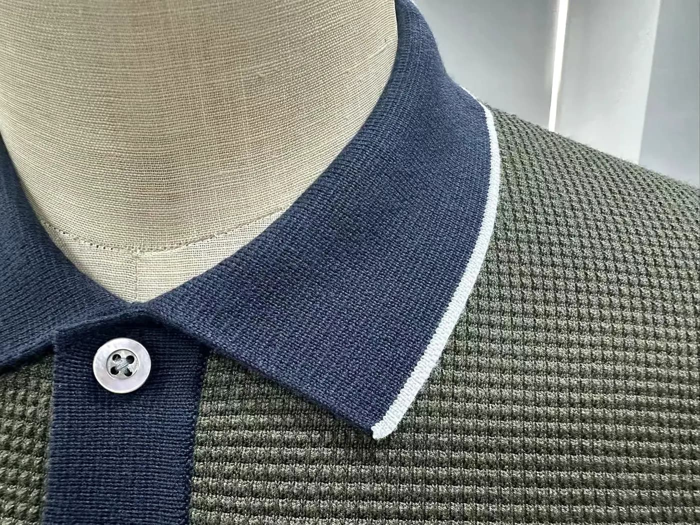 Close-up of a knit collar and placket construction at Licheng Knitwear