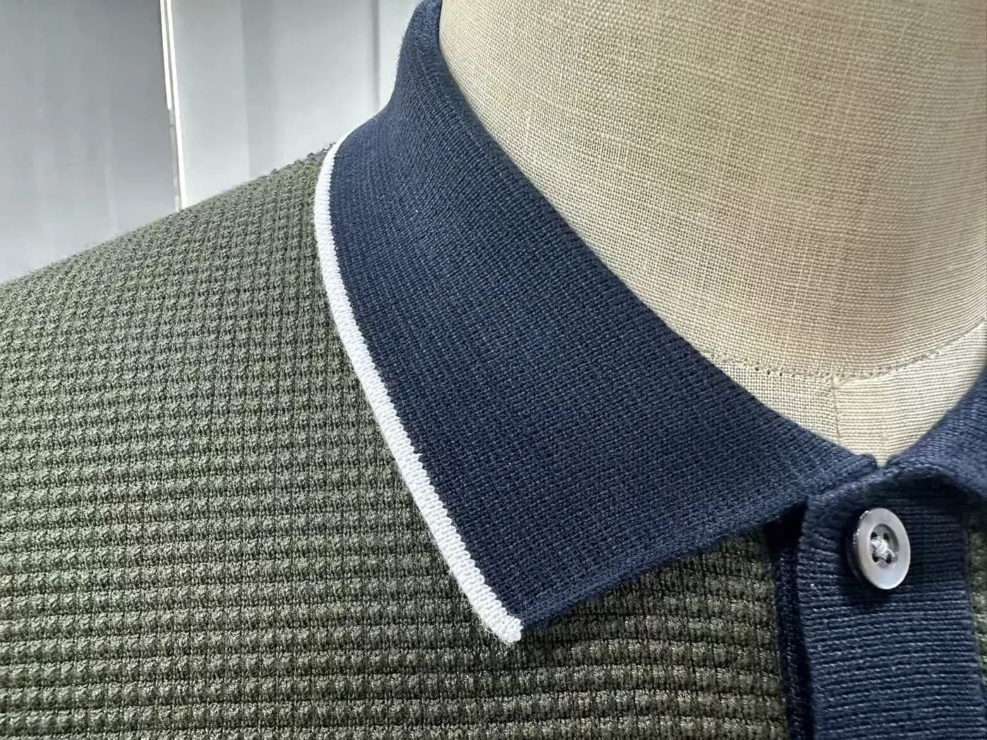 Knit polo collar and placket construction for private-label programmes.
