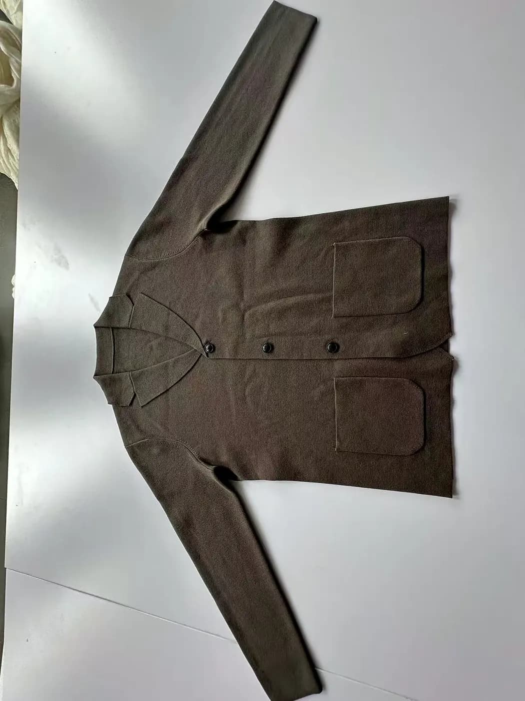 Pressed knit surface after finishing, showing even stitch quality.