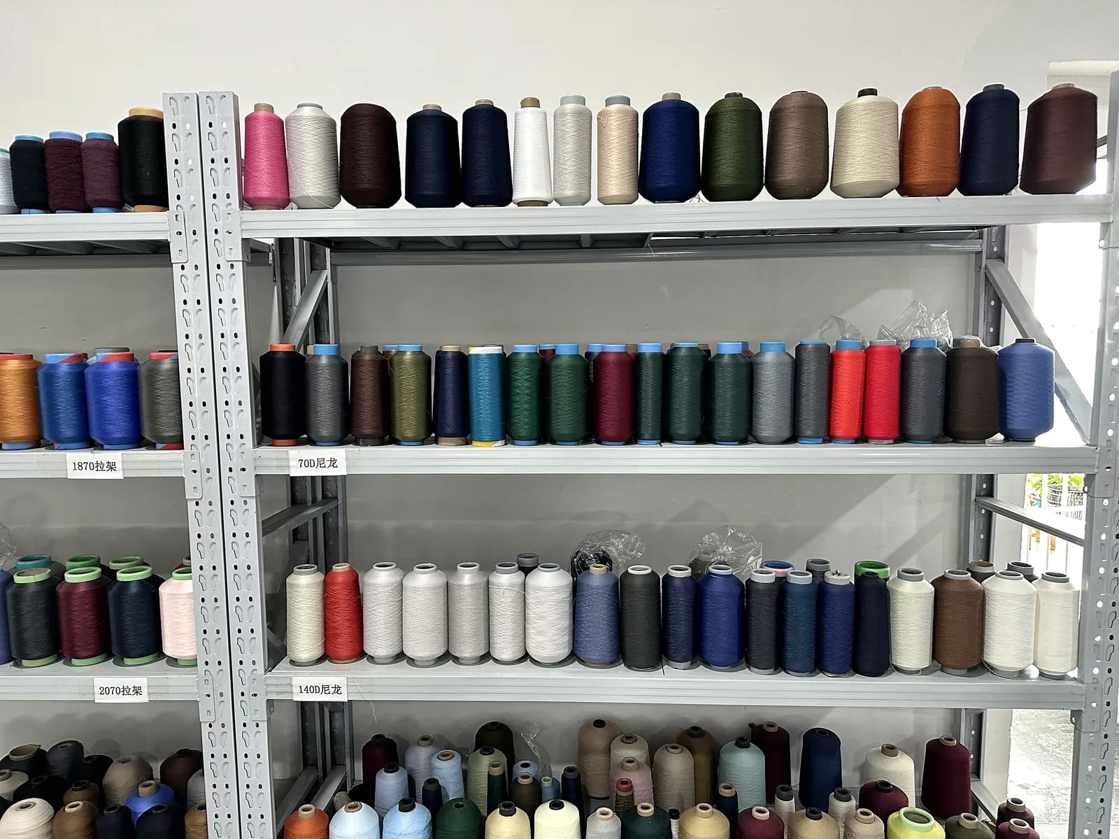 Yarn cone inventory racks in the Licheng Knitwear yarn store.