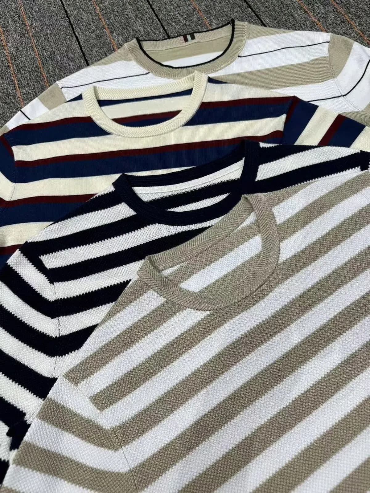 Striped crew-neck knit samples in seasonal colourways for North American menswear buyers.
