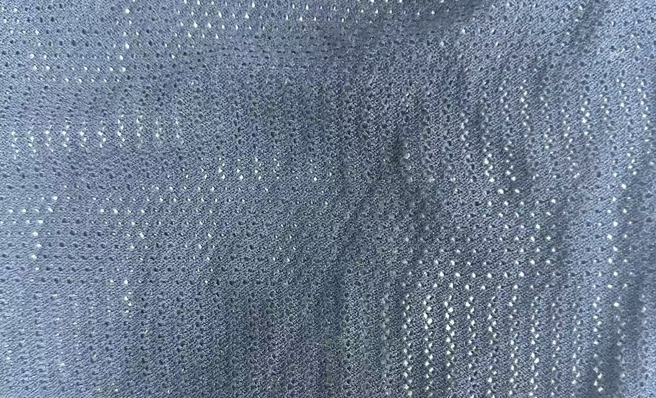 Fine 12GG pointelle knit in slate with a fine rib hem, showing the open stitch structure